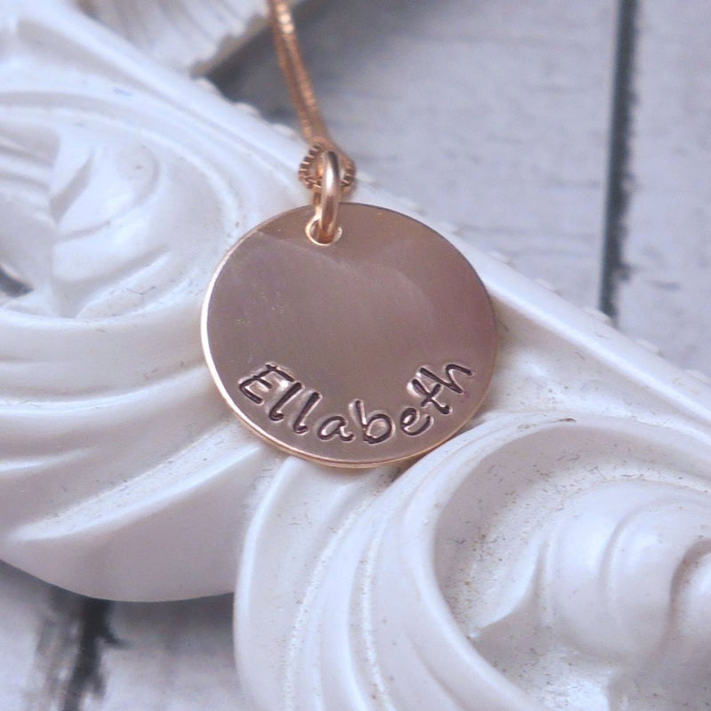 Personalized Rose Gold Mothers Necklace with Kids Name, flat lay over a frame